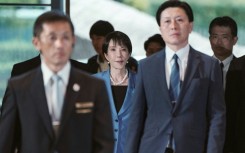Japan's new Prime Minister Sanae Takaichi (C) arriving at the prime minister's office after being appointed by the parliament, in Tokyo