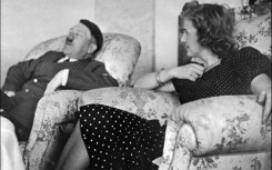 This undated and unlocated picture shows Hitler relaxing with his mistress Eva Braun