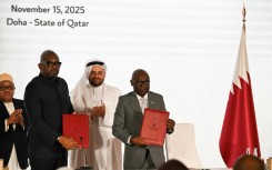 Officials from the rival DR Congo government and the Rwanda-backed M23 movement stand with a Qatari negotiator at the signing of a new roadmap seeking to establish a permanent peace in devastated eastern DRC