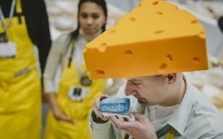 Kuba Maziarczyk sniffs a piece of cheese