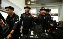 Palestinian national football team members wear the traditional Basque "txapela" (beret) as they arrive at Bilbao airport ahead of a match against the Basque national team