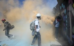 Police protecting the compound used tear gas grenades and fire extinguishers to contain the protesters
