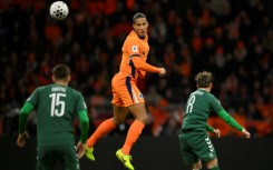 Heading to the World Cup: Virgil van Dijk of the Netherlands out jumps two Lithuanians