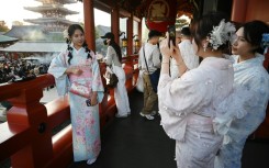 Chinese tourists wear kimonos as they visit the Sensoji Temple in Tokyo