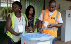 A National Electoral Commission official seals a ballot box before polls open