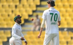 South Africa's captain Temba Bavuma (left) speaks with pace bowler Marco Jansen