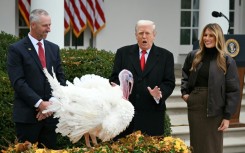 First Lady Melania Trump looks on as US President Donald Trump pardons Gobble, one of the National Thanksgiving turkeys, during a ceremony in the Rose Garden