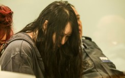 Flanked by security guards and a translator, 45-year-old Hakyung Lee showed little reaction as the sentence was handed down