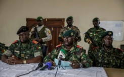 Brigadier General Denis N'Canha (C), head of the military office of the presidency, gave a press conference announcing the takeover