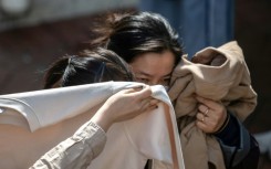 People mourn after identifying bodies in the aftermath of a major fire that swept through several apartment blocks at the Wang Fuk Court residential estate in Hong Kong's Tai Po district