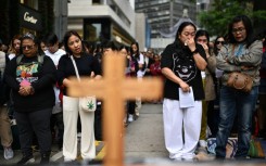 Filipinas in Hong Kong take part in a prayer service for victims of the Tai Po fire. At least 10 of the 146 killed were migrant workers
