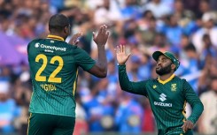 South Africa's Lungi Ngidi (L) celebrates with captain Temba Bavuma after taking the wicket of India's Virat Kohli