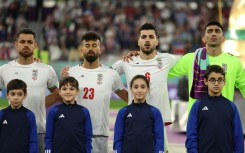 Iranian players sing the national anthem before their World Cup match against the USA at the 2022 tournament in Qatar