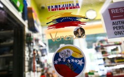 Venezuela-themed stickers decorate a window in the Doral food mart