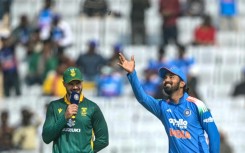 India's captain KL Rahul (R) tosses the coin as his South African counterpart Aiden Markram watches before the start of the first one-day international Ranchi. India have defied million-to-one odds to lose 20 tosses in a row