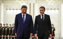 China's President Xi Jinping (L) and France's President Emmanuel Macron attend a welcome ceremony at the Great Hall of the People in Beijing on December 4, 2025