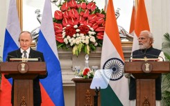 Russia's President Vladimir Putin (L) speaks as India's Prime Minister Narendra Modi listens during their joint press statements after their meeting at the Hyderabad House in New Delhi on December 5, 2025