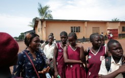 Sexual health activist Fatou Esther Jusu interacts with school girls at a secondary school in Freetown in October 2025