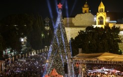 People packed the square in Bethlehem to watch the tree lit up during a two-hour ceremony, metres away from the Church of the Nativity