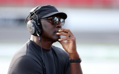 Michael Jordan, NBA Hall of Famer and co-owner of 23XI Racing listens to a race on pit road in October 2025