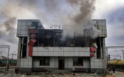 Smoke rises from a heavily damaged train station building in the town of Fastiv in Ukraine's Kyiv region after an air attack