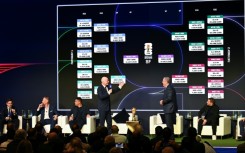 FIFA president Gianni Infantino (center-L) speaks on stage on Saturday as the match schedule for the 2026 World Cup is revealed