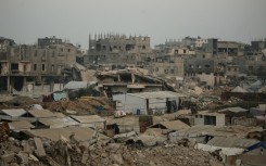 Displaced Palestinians set up their tents surrounded by rubble from buildings destroyed by the Israeli military in central Gaza