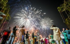 People watch fireworks light up the sky as part of Diwali celebrations in Mumbai in October