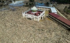 An aerial view shows vast remains of uprooted trees at the Darul Mukhlisin Islamic boarding school and mosque in the aftermath of flash floods at Aceh Tamiang