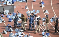 Disappointed fans pelted security officials with chairs ripped from the stadium