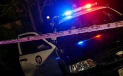 A Los Angeles Police Department patrol car behind police tape in the Brentwood neighborhood of Los Angeles, California