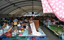 Displaced residents rest at an evacuation centre at Chang International Circuit in the Thai border province of Buriram
