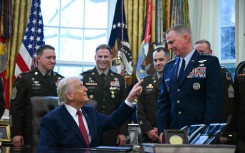 US President Donald Trump speaks with military officers at the White House