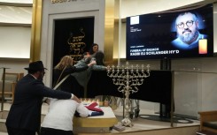 Many mourners were overcome with grief as they saw the black casket carrying rabbi Eli Schlanger.