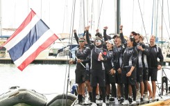 This pool photo taken and released on December 18, 2025 shows Thailand's Queen Suthida (C) celebrating with her team