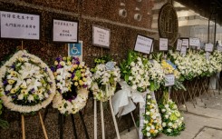 Floral tributes placed in mourning at the funeral for firefighter Ho Wai-ho, who died in the deadly fire at the Wang Fuk Court