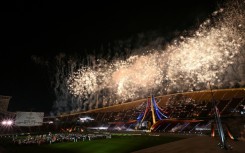 Athletes watch fireworks during the closing ceremony of the 33rd Southeast Asian Games in Bangkok, with host Thailand topping the medal charts with 233 golds