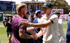 Australia's Pat Cummins (R) shakes hands with England captain Ben Stokes (L) after the third Adelaide Test
