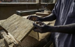 A man works as a carpenter in a workshop dedicated to training former child soldiers in the Democratic Republic of Congo