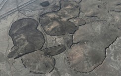 Between the cities of Nasiriyah and Samawah, not far from ancient Sumerian ruins, labourers are working hard to stabilise the soil by applying a layer of moist clay