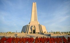 Cambodian Buddhist monks participate in a prayer for peace at the Win-Win monument