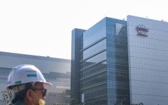 A worker walks past the 2-nanometer fabrication plant of TSMC at Nanzih Technology Industrial Park in Kaohsiung on December 23, 2025