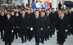 South Korean President Lee Jae Myung (centre) walks with his cabinet members as he visits the National Cemetery in Seoul on January 1. Soaring global demand for semiconductors fuelled by a boom in artificial intelligence sent South Korea's exports to their highest-ever level in 2025