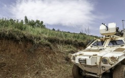 A UN peacekeeping mission armoured vehicle patrols a road in Ituri province