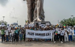 Supporters of Benin's President Patrice Talon waved banners reading 'Never Again' after a failed coup attempt in December