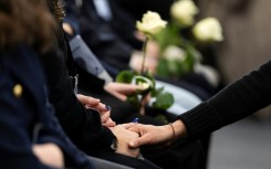 Attendees at the ceremony in Martigny held white roses in memory of the victims of the Crans-Montana fire tragedy