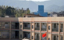 The Yayang church (at rear) is seen covered in scaffolding in Yayang township, Wenzhou city