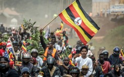 Bobi Wine supporters wave the flag at a rally this week
