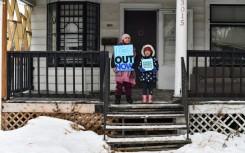 Children hold signs along the route of the protest march in Minneapolis