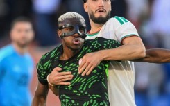 Osimhen holds off Ramy Bensebaini during Nigeria's quarter-final win over Algeria in Marrakesh